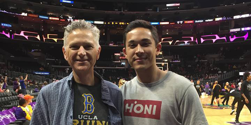 Robert Earnest '84 and his son courtside at a Los Angeles Sparks basketball game