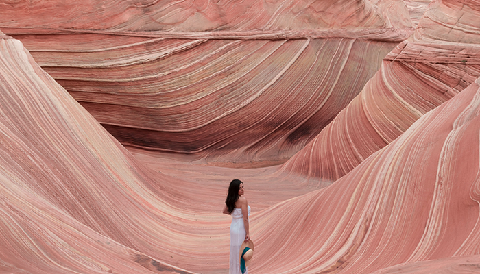 Stephanie poses in front of a sandstone rock formation in Arizona called 