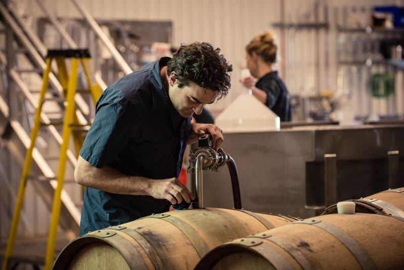 Gavin Chanin ’09 inspects the product inside the barrel