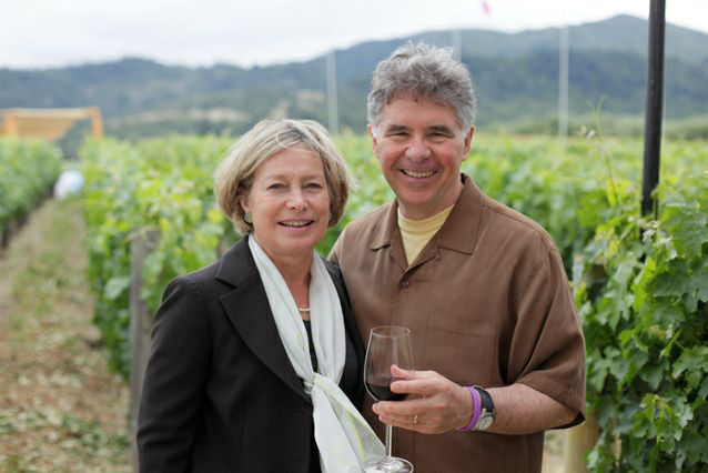 Garen ’66 and Shari ’66 Staglin at their vinyard. Gary has a fresh glass of red in his hand