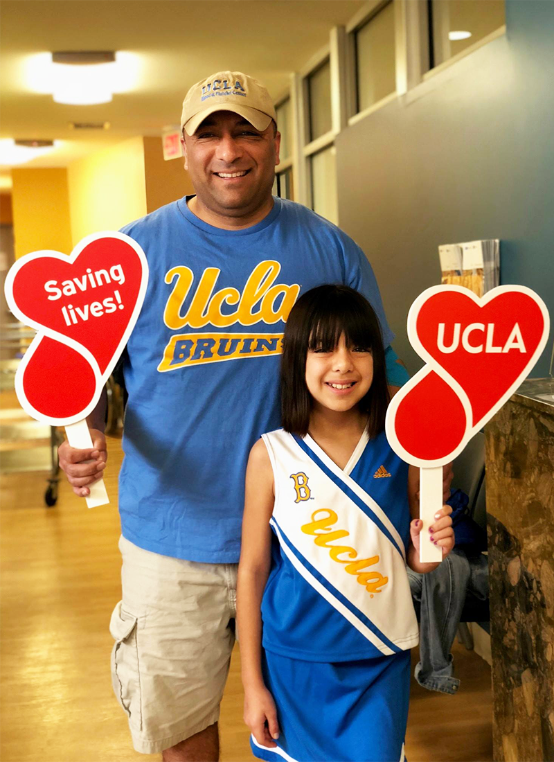 A man and his daughter at the UCLA Beat 'SC Blood Drive'