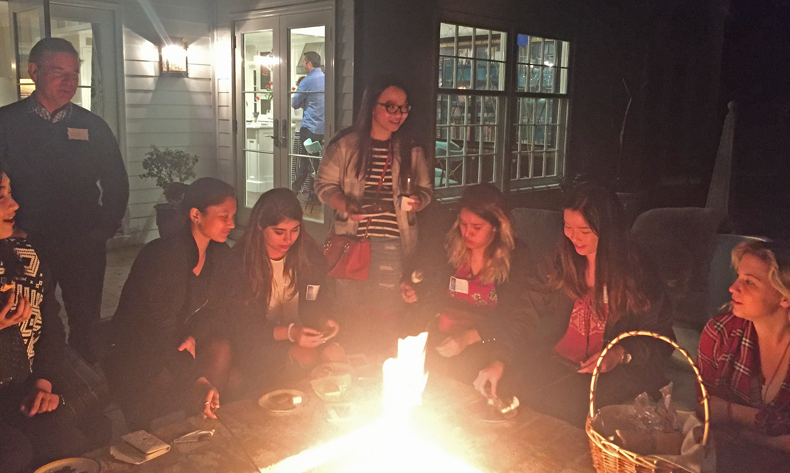 Dinner guests make s’mores after dinner in the Calverts’ home.
