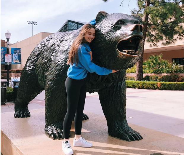 Student hugs Bruin Bear