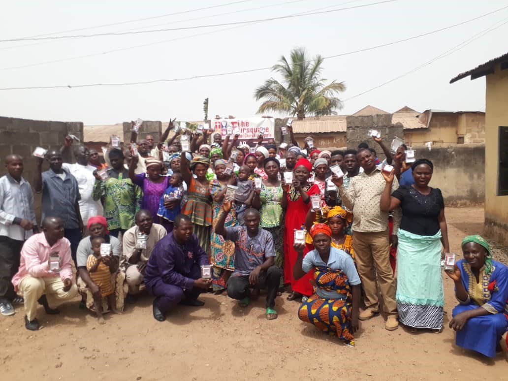 Nigerian students and teachers with solar lamp lights