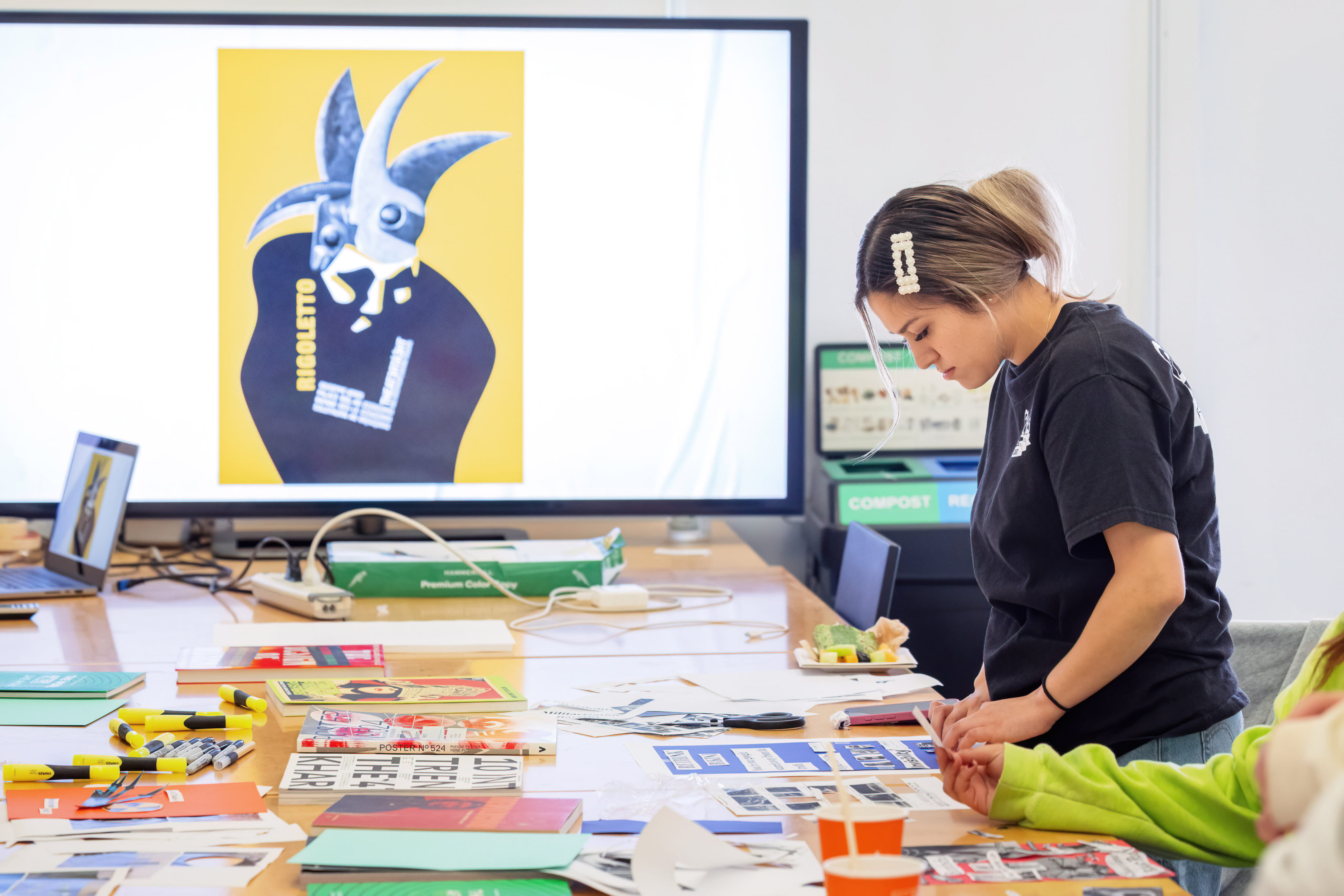 Student crafting a paper project in studio