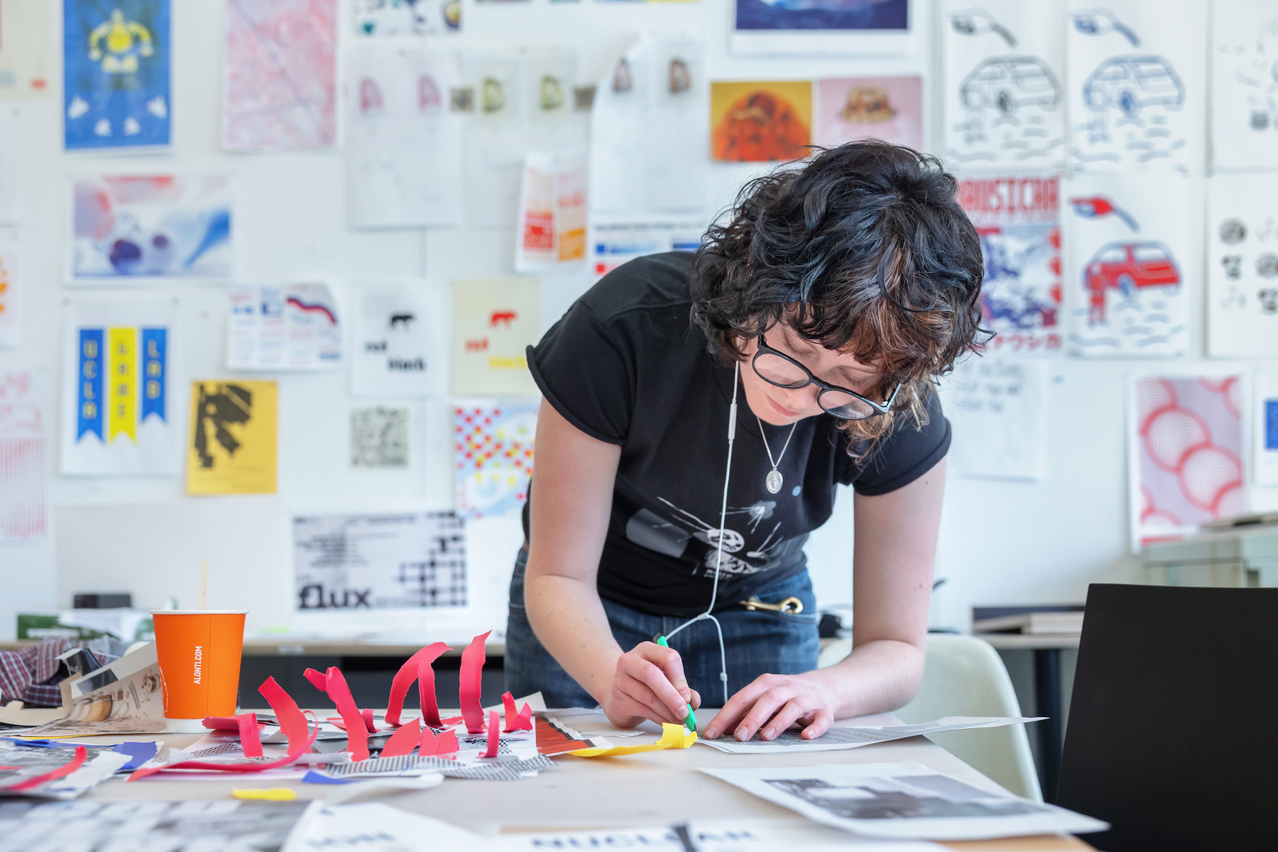 Student crafting a paper project in studio